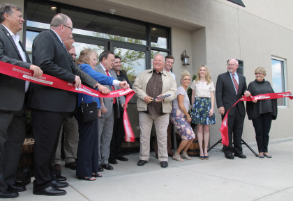Legendary racecar driver A.J. Foyt cuts the ribbon at the opening of the Foyt Wine Vault in Speedway, Indiana (Sarah Stierch, CC BY 4.0)
