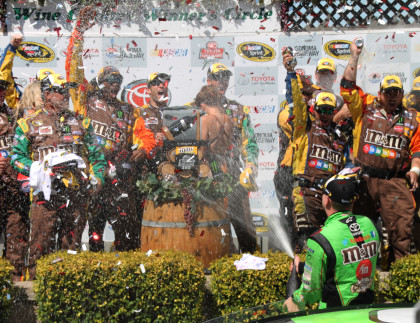 Kyle Busch sprays Korbel sparkling wine at his team mates in celebration of his victory (Photo: Sarah Stierch, CC BY 4.0) 