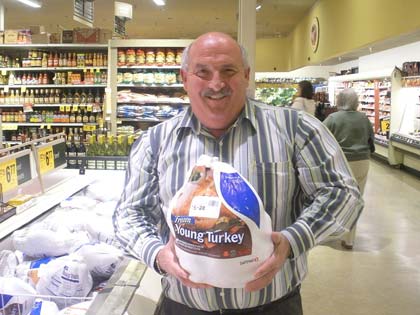 Staff Photo Bill Dardon, sometimes known as “Mr. Turkey,” gets ready to give away one of the 1,500 turkeys he donates each year to Valley families in need.