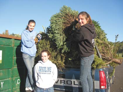 Staff Photo Members of Girl Scout Troop 332, from left, Jacquilynn McRice, Allison Harf and Tori Dwyer, take part in the Scout’s annual Christmas tree recycling program.